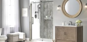 An modern bathroom with a gray walk-in shower with a glass door