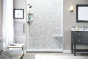 A modern bathroom with a walk-in shower that has white-and-gray walls