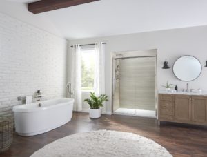 A modern bathroom with a wood floor, a walk-in shower, and a tub.
