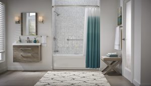  A beautiful bathroom with gray walls, a gray and white bathtub enclosure, an ombre teal shower curtain, and a floating gray vanity.