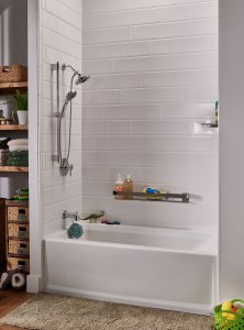 A white bathtub with a white tile shower